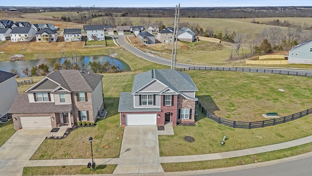 bird's eye view with a residential view and a water view