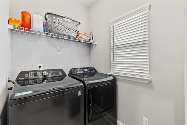 washroom featuring laundry area and washing machine and clothes dryer