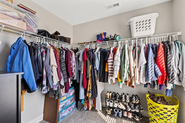 spacious closet featuring visible vents and carpet floors