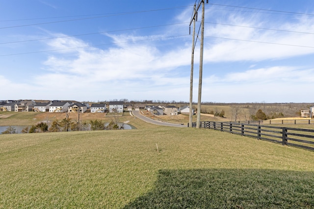 view of yard featuring a residential view and fence