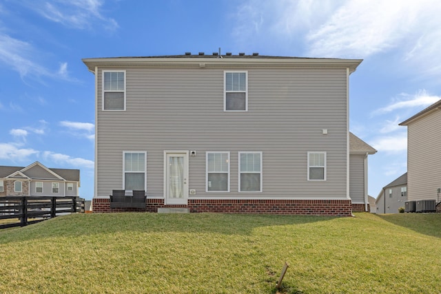 back of property featuring a lawn, central AC, and fence