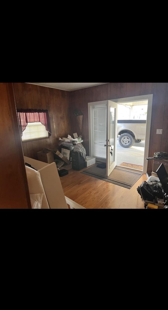 foyer entrance featuring wooden walls and wood finished floors