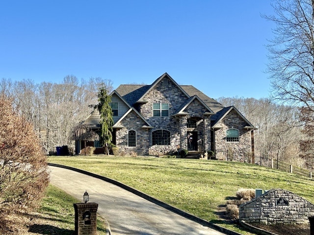 view of front of home featuring fence and a front lawn