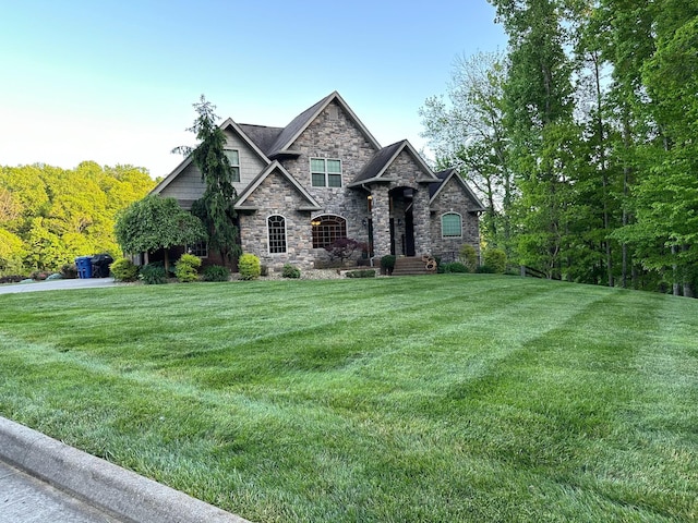 view of front facade featuring stone siding and a front lawn