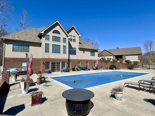 view of swimming pool with a patio, fence, and a fenced in pool