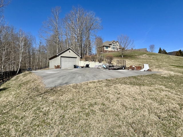 view of yard featuring a detached garage and an outdoor structure