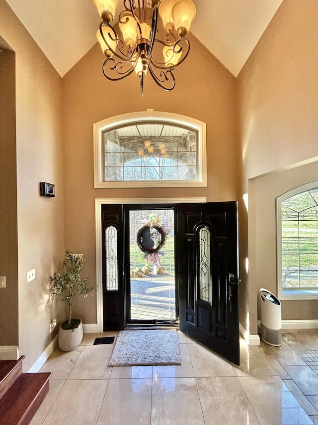 entryway with high vaulted ceiling and baseboards