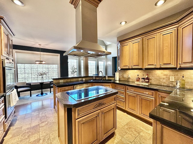 kitchen with black electric stovetop, a peninsula, decorative backsplash, island exhaust hood, and stone tile flooring