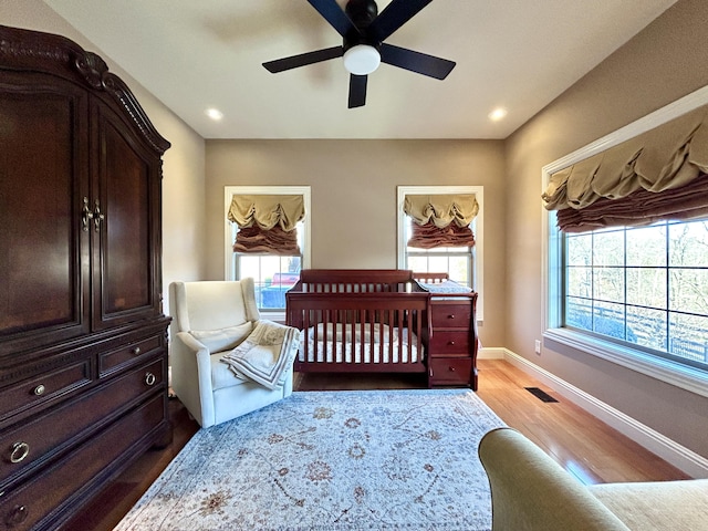 bedroom with light wood finished floors, visible vents, baseboards, and recessed lighting