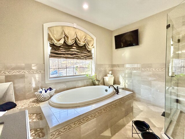 full bathroom with a garden tub and a shower stall