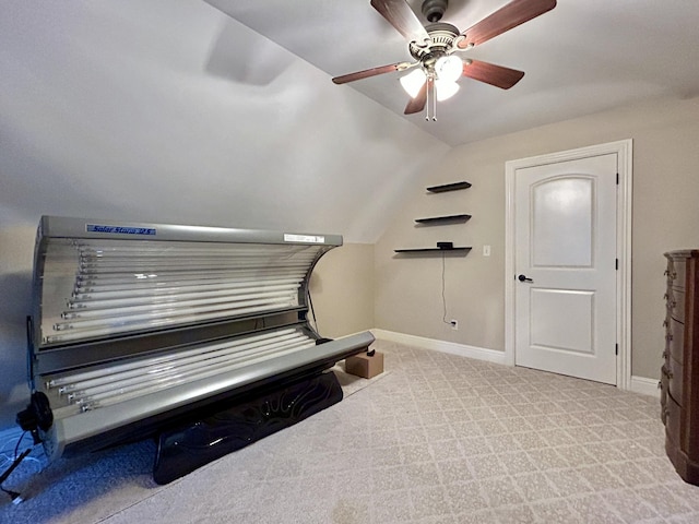 misc room with vaulted ceiling, carpet flooring, and baseboards