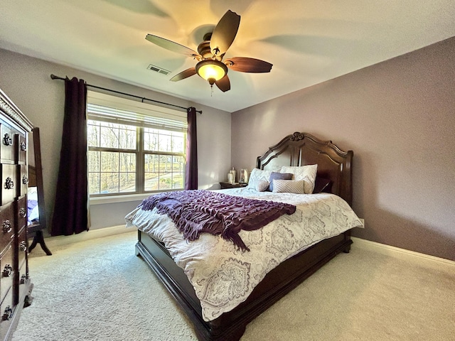 bedroom featuring light carpet, baseboards, visible vents, and ceiling fan