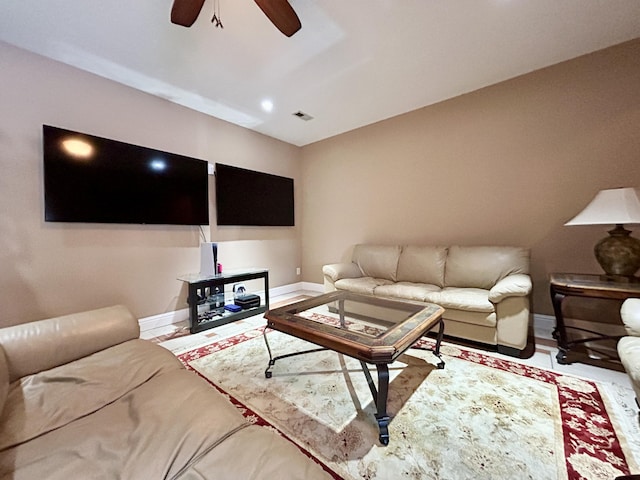 living area featuring a ceiling fan, visible vents, and baseboards