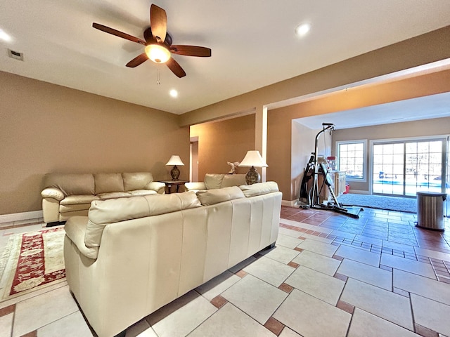 living area featuring baseboards, a ceiling fan, visible vents, and recessed lighting