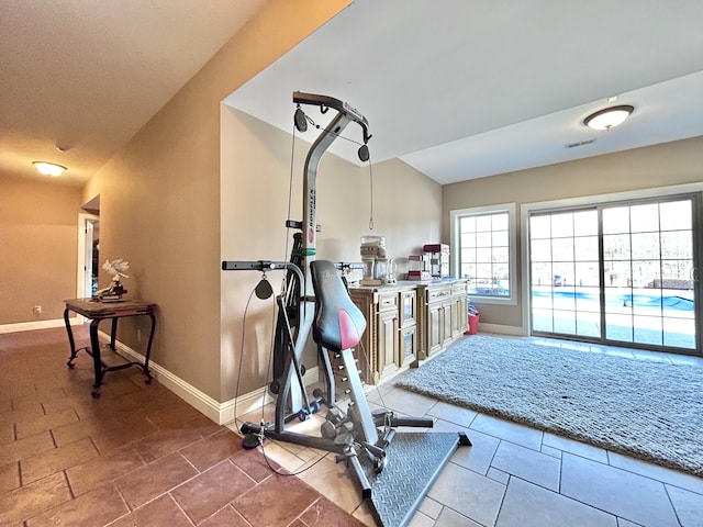 exercise area with visible vents and baseboards