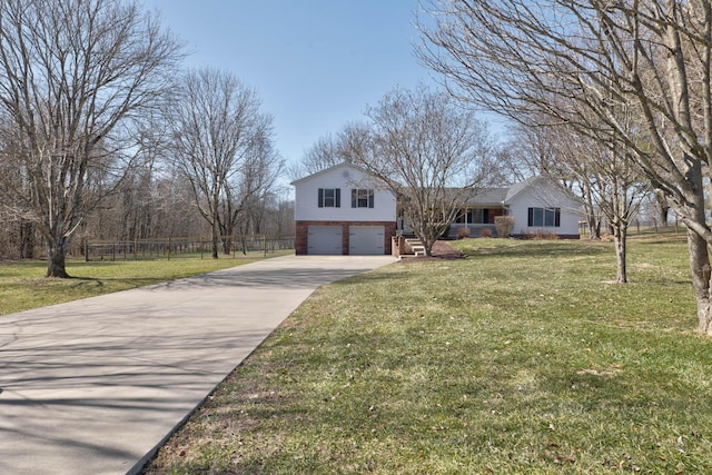 view of front of property with brick siding, concrete driveway, an attached garage, fence, and a front yard