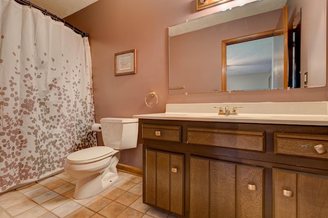 bathroom featuring curtained shower, tile patterned flooring, vanity, and toilet