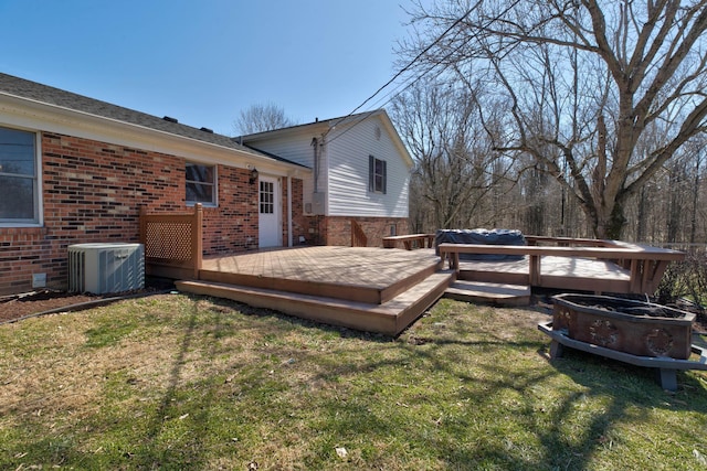 exterior space featuring a grill, a lawn, and central air condition unit