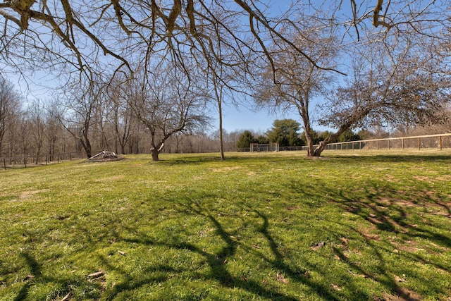 view of yard featuring a rural view and fence