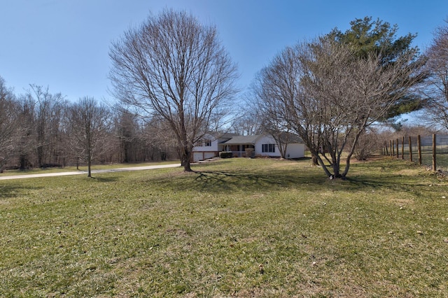 view of yard with a garage and fence