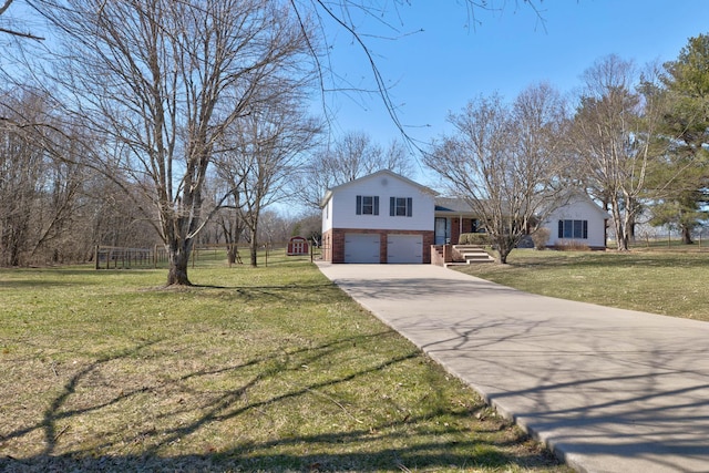 tri-level home with an attached garage, driveway, a front lawn, and brick siding