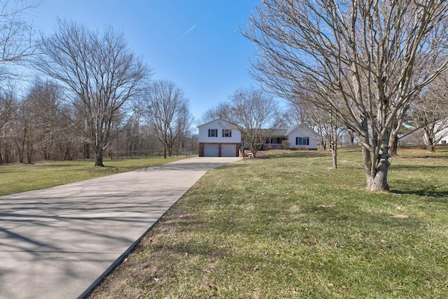 view of front of house featuring a garage, a front yard, and concrete driveway