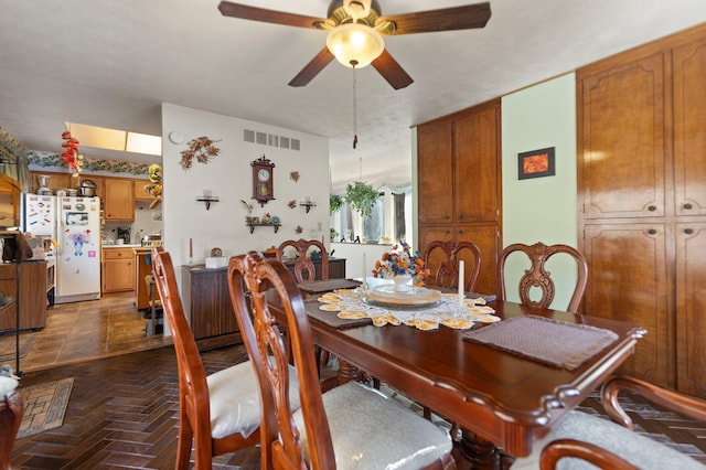 dining room featuring a ceiling fan and visible vents