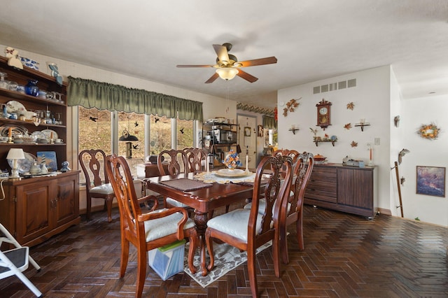 dining room with ceiling fan and visible vents