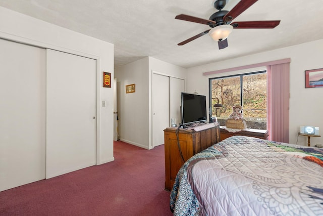 bedroom with carpet, baseboards, ceiling fan, and multiple closets