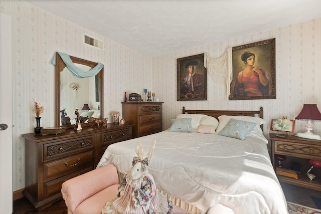 bedroom featuring visible vents and wallpapered walls