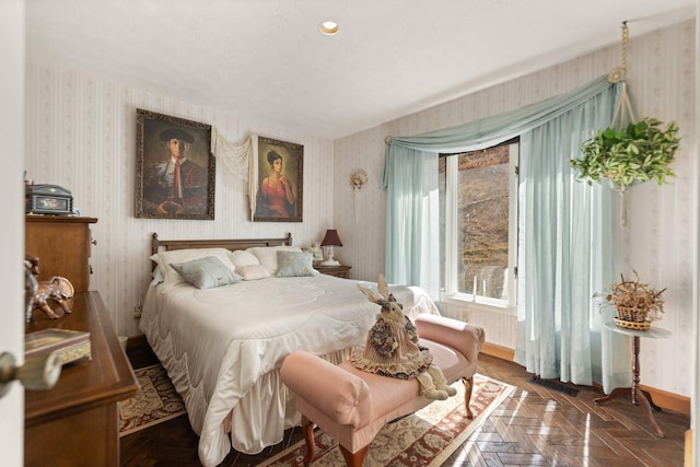 bedroom featuring wallpapered walls and baseboards