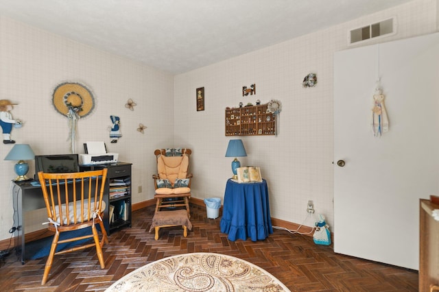 office with visible vents, a textured ceiling, and baseboards