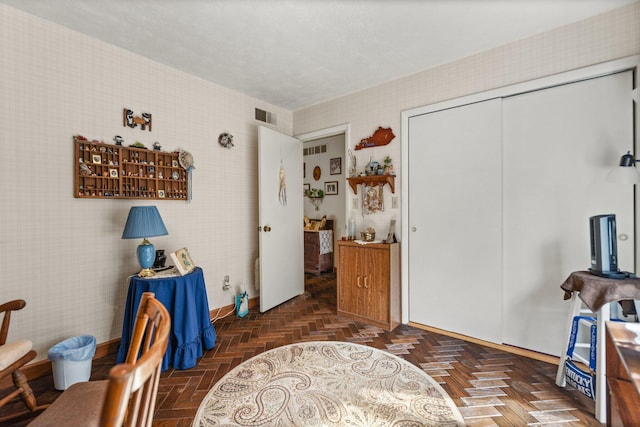 interior space featuring baseboards, visible vents, and a closet