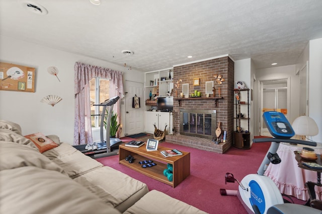 carpeted living area featuring a brick fireplace and a textured ceiling