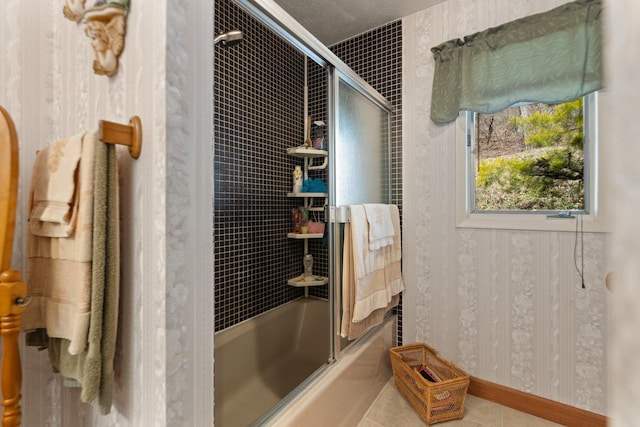 bathroom featuring bath / shower combo with glass door and tile patterned floors