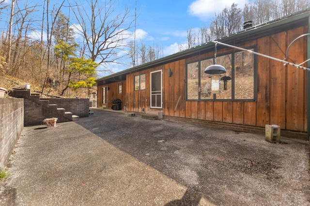 view of property exterior featuring a patio area and fence