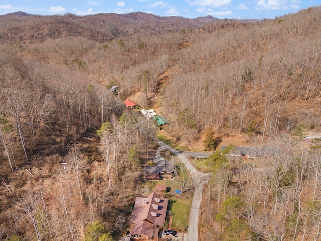 aerial view featuring a forest view and a mountain view