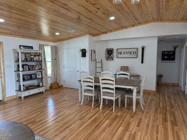 dining room featuring vaulted ceiling, light wood-style flooring, wood ceiling, and baseboards