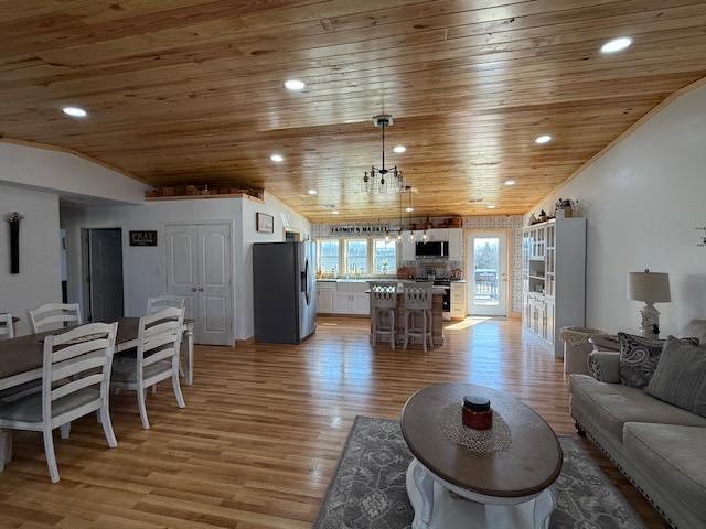 living area with recessed lighting, wooden ceiling, vaulted ceiling, and light wood finished floors