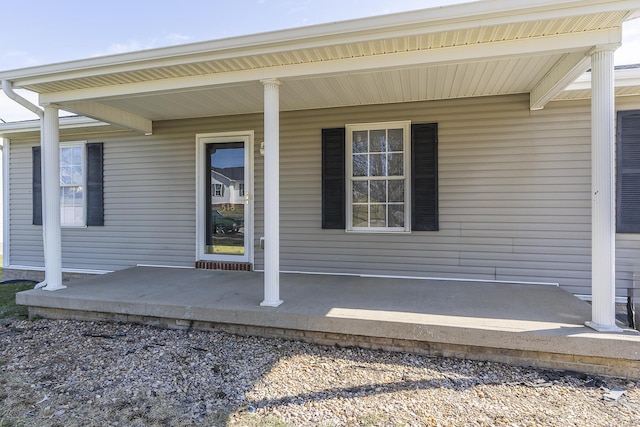 view of exterior entry with covered porch