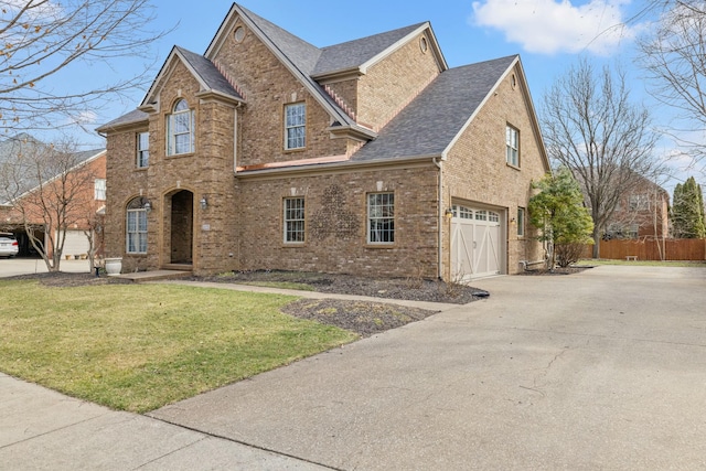 traditional-style home featuring brick siding, roof with shingles, a garage, driveway, and a front lawn