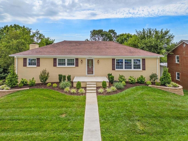 single story home with a chimney and a front yard