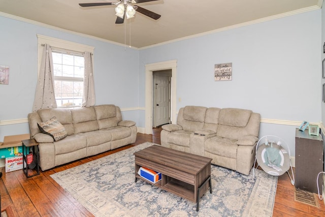 living area featuring baseboards, crown molding, hardwood / wood-style floors, and ceiling fan