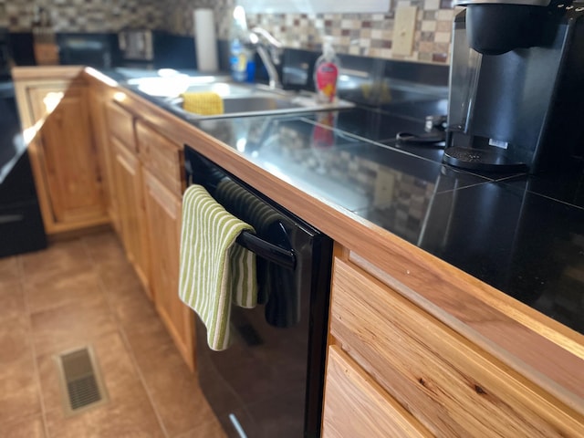 2704 Dewitt St, Flatwoods, KY 41139 - kitchen with black dishwasher, light tile patterned floors, visible vents, and tasteful backsplash