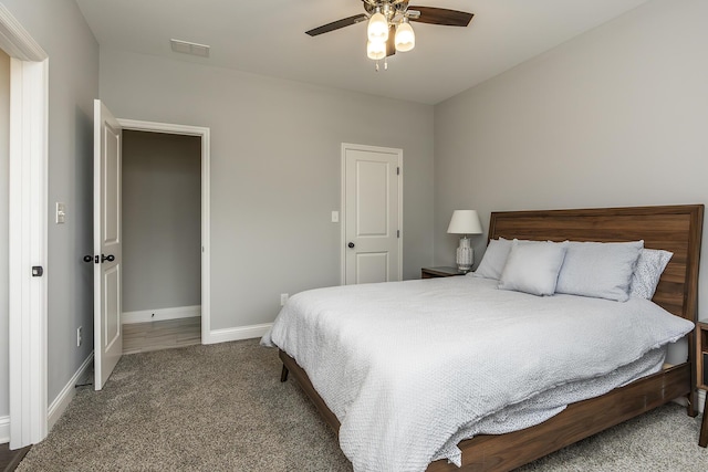 bedroom with carpet floors, visible vents, baseboards, and a ceiling fan