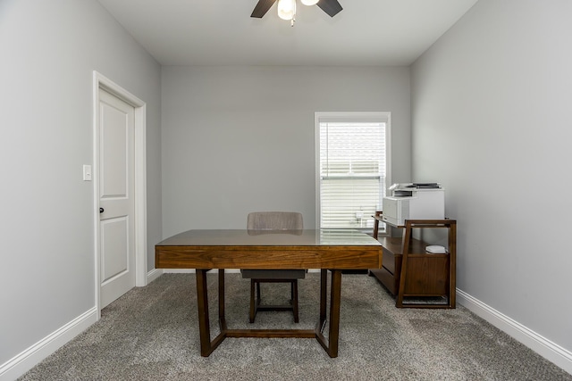 home office with light carpet, ceiling fan, and baseboards