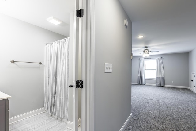 bathroom featuring ceiling fan, vanity, and baseboards