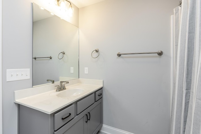 bathroom with vanity and baseboards