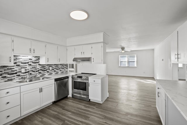 kitchen featuring light countertops, appliances with stainless steel finishes, white cabinetry, a sink, and under cabinet range hood