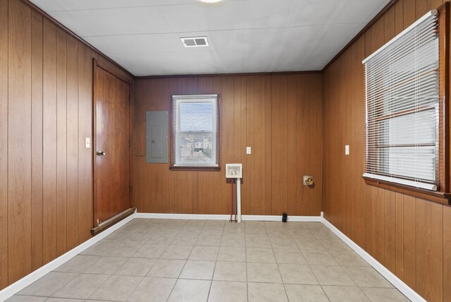 washroom with laundry area, baseboards, electric panel, and visible vents